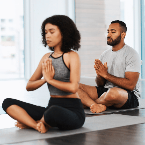 Two people on the floor in a yoga pose